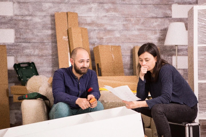 Confused couple attempting to assemble furniture